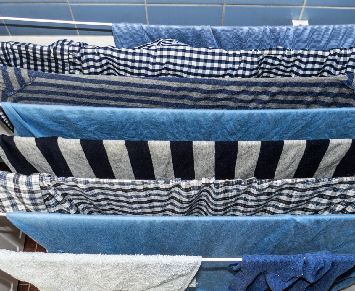 Blue clothing drying on a rack
